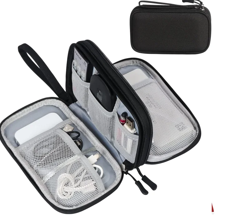A zipped cable organizer opened flat, cables, a charger and a power bank held in mesh compartments